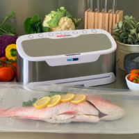 Grey and white vacuum sealer with vacuumed sealed fish