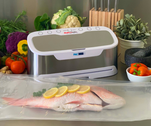 Grey and white vacuum sealer with vacuumed sealed fish